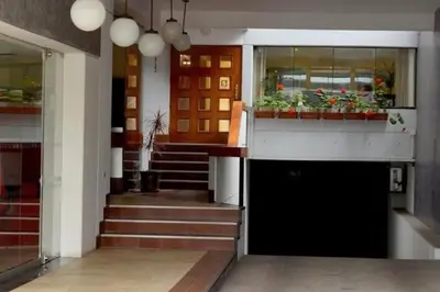 a lobby with stairs and potted plants on the windows at Loft en el centro de San Isidro Pet Friendly in Lima