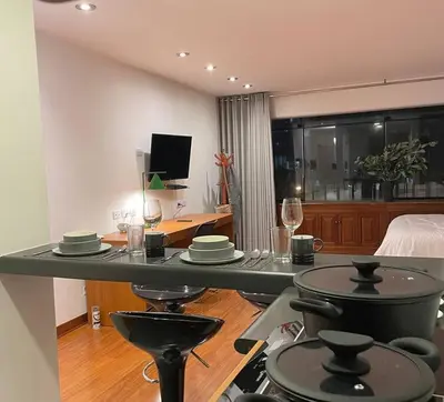 a kitchen with a counter with plates and wine glasses at Loft en el centro de San Isidro Pet Friendly in Lima