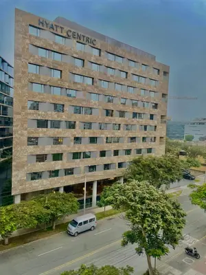 a building with a van parked in a parking lot at Loft en el centro de San Isidro Pet Friendly in Lima