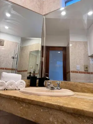 a bathroom counter with a sink and a mirror at Loft en el centro de San Isidro Pet Friendly in Lima