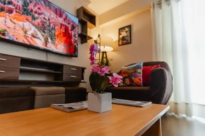 a living room with a table and a couch at Family-Friendly 2BR in Prime Location in Lima