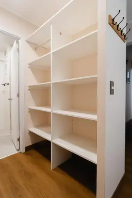 a walk in closet with white shelves at Family-Friendly 2BR in Prime Location in Lima