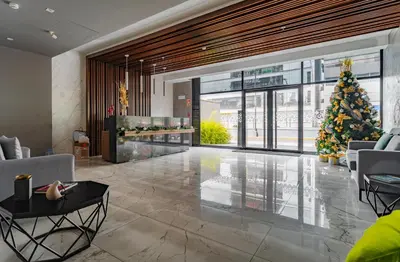 a living room with a christmas tree and a lobby at Family-Friendly 2BR in Prime Location in Lima