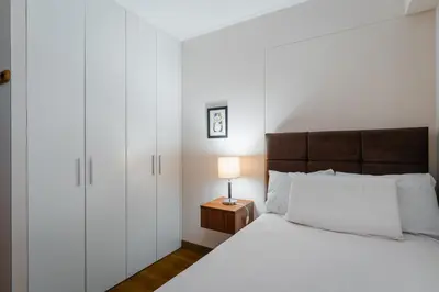 a bedroom with a bed and a nightstand with a lamp at Family-Friendly 2BR in Prime Location in Lima