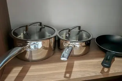 three pots and pans sitting on top of a shelf at Apartamento completo en Barranco in Lima