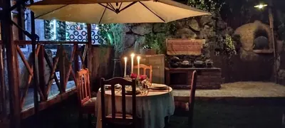 a table with an umbrella in a room at Casa Jazmín Hospedaje Familiar Eco Amigable - Huayoccari, Sacred Valley in Huayoccare