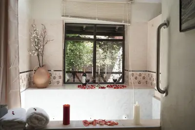 a bathroom with a window and a counter with candles at Casa Jazmín Hospedaje Familiar Eco Amigable - Huayoccari, Sacred Valley in Huayoccare
