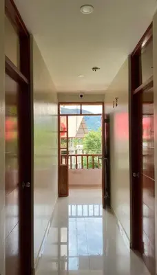 a hallway with doors and a view of a balcony at LagunaNegra Oxapampa in Palmira
