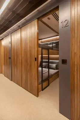 a walk in closet with bunk beds in a room at Sleepover - Lima Airport, the only in-terminal sleep pods in Lima