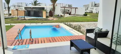 a swimming pool with a person in the water at Condominio Nautico Paracas in Ica