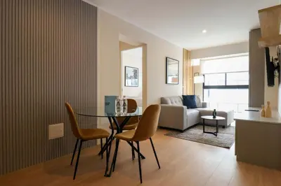 a living room with a table and chairs and a couch at Barron by Wynwood House in Lima