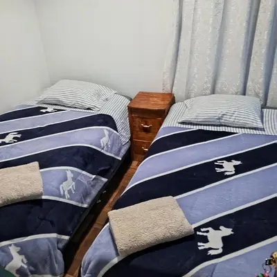 two beds sitting next to each other in a bedroom at Hospedaje Rochi House - Cusco- En el Corazón del Cusco in Cusco