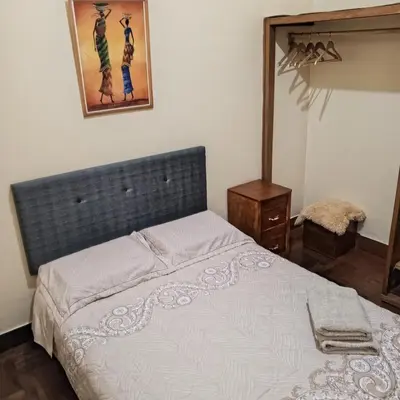a bedroom with a bed and a picture on the wall at Hospedaje Rochi House - Cusco- En el Corazón del Cusco in Cusco