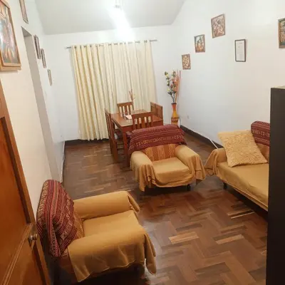 a living room with a couch and chairs and a table at Hospedaje Rochi House - Cusco- En el Corazón del Cusco in Cusco