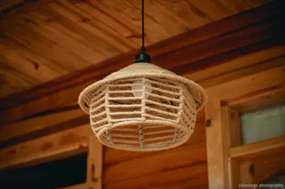 a crochet light hanging from the ceiling of a cabin at Palo Alto Lodge in Oxapampa