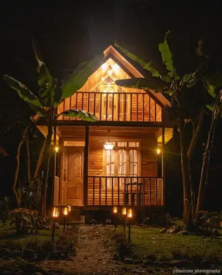 a house at night with lights in front of it at Palo Alto Lodge in Oxapampa