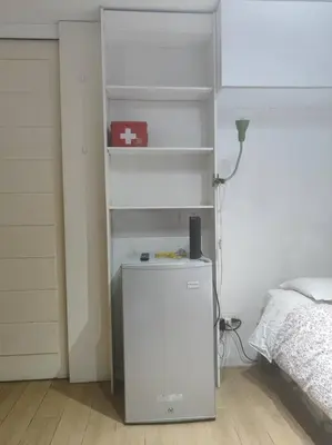 a room with a bed and a white shelf at Cómodo Estudio Miraflores in Lima