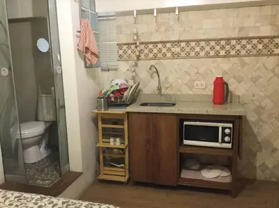 a small kitchen with a sink and a microwave at Cómodo Estudio Miraflores in Lima