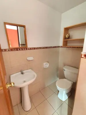 a bathroom with a toilet and a sink at Casa Campo Isabel Quinteros in Chaclacayo
