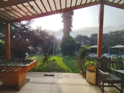 a porch with a view of a green yard at Casa Campo Isabel Quinteros in Chaclacayo