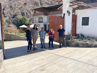 a group of people standing outside of a building at HOTEL HUAYTARA CasaBlanca in Huaytará