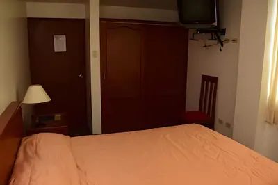 a bedroom with a bed and a television in it at Incasol Tower 