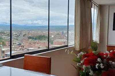 a room with large windows and a vase of flowers at Incasol Tower 