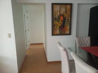 a dining room with a glass table and a painting at Depa El Polo, Embajada USA, Surco in Lima