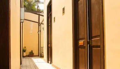 an empty alley with an open door in a building at Villa La Punta in Lima