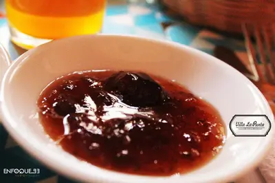 a bowl of food with sauce in it on a table at Villa La Punta in Lima