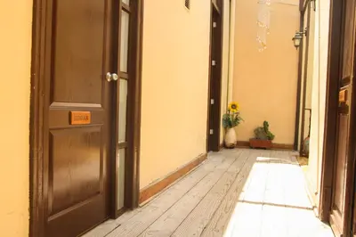 an empty hallway with an open door and a plant at Villa La Punta in Lima