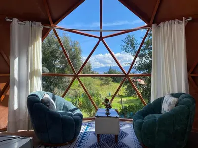 two chairs in a room with a large window at Antawara Glamping in Chipingura