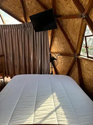 a bedroom in a dome tent with a bed at Antawara Glamping in Chipingura