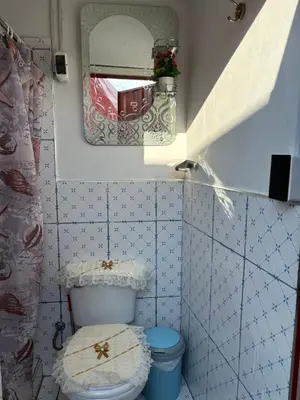 a bathroom with a toilet and a mirror at Antawara Glamping in Chipingura