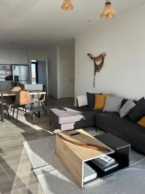 a living room with a couch and a table at Aldea Bayfront Heaven Paracas in Paracas