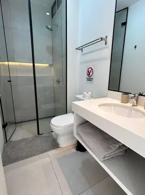 a bathroom with a toilet and a sink and a shower at Aldea Bayfront Heaven Paracas in Paracas