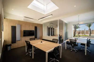 an office with two tables and chairs and a television at Aldea Bayfront Heaven Paracas in Paracas