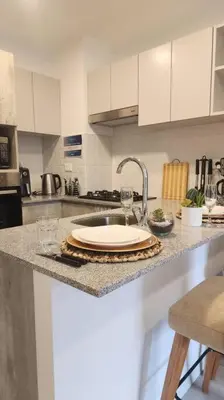 a kitchen counter with a sink with a plate on it at Hermoso departamento in Lima