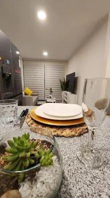 a table with a plate of food and a wine glass at Hermoso departamento in Lima