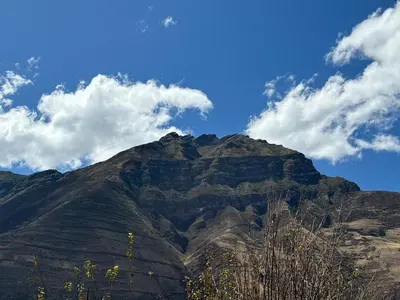 a mountain with a blue sky and clouds at Tambo Real Valle Sagrado in Yucay