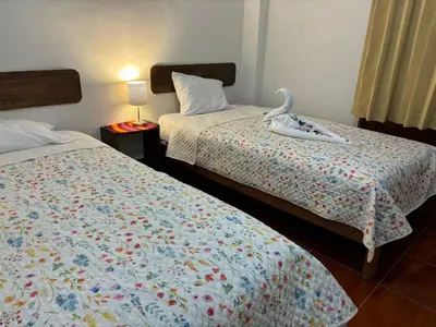 a bedroom with two beds with a swan on them at Tambo Real Valle Sagrado in Yucay