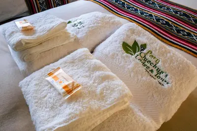 a group of towels sitting on a bed at PERU QUECHUA'S LODGE Riverside in Ollantaytambo