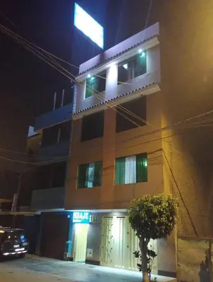 a building with a car parked in front of it at night at Hospedaje D Francisco in Lima