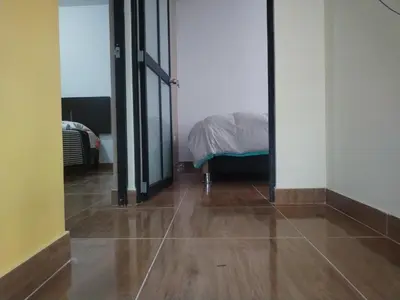 a room with a bed and a wooden floor at Yompor's haus in Oxapampa