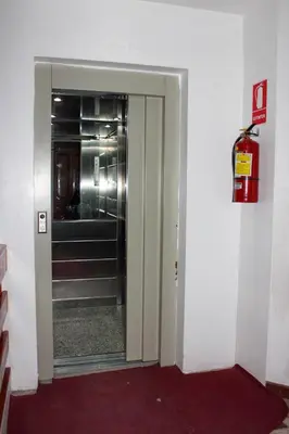 an open door to a hallway with a fire extinguisher at Hotel Wiracocha Machupicchu in Machu Picchu