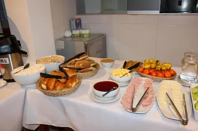 a table with baskets of bread and other foods on it at Hotel Wiracocha Machupicchu in Machu Picchu