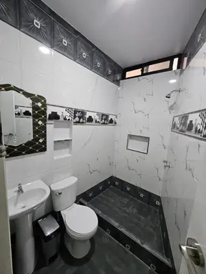 a black and white bathroom with a toilet and a sink at Hotel Sumac Samari in Puquio