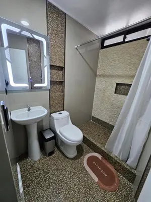 a bathroom with a toilet and a sink and a shower at Hotel Sumac Samari in Puquio