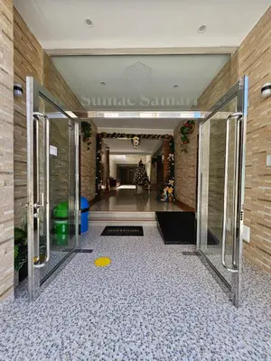 a hallway with a glass door in a building at Hotel Sumac Samari in Puquio