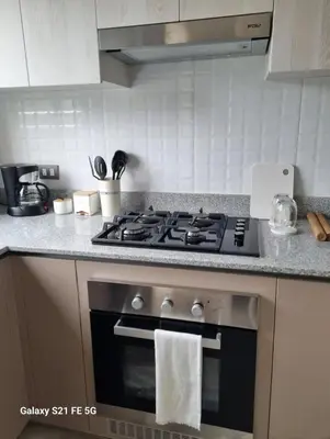 a kitchen with a stove with a towel on the oven at María Paz Home in Lima